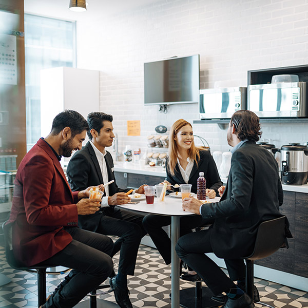 coworkers having lunch together in break room