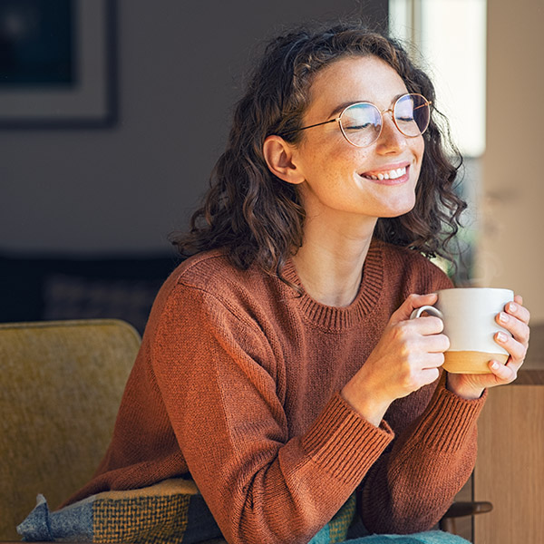 woman enjoying a cup of coffee inside