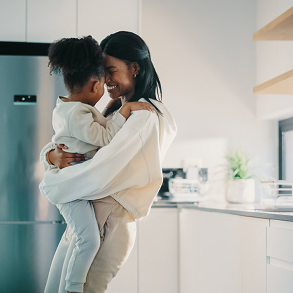 mom and daughter hugging in the kitchen