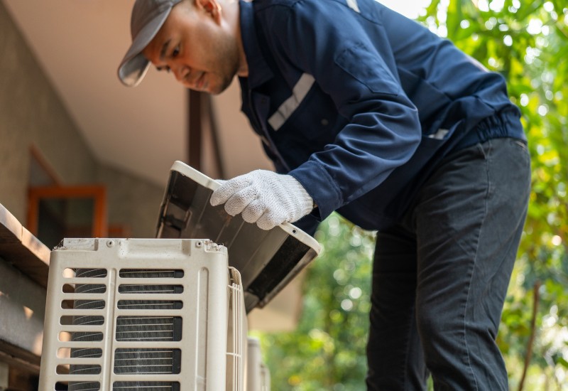 Technician working on air conditioning maintenance in Edmonton & Spruce Grove